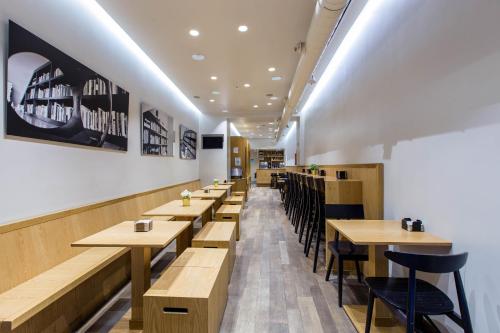 a row of tables and chairs in a restaurant at Hostal Sol Square Madrid in Madrid