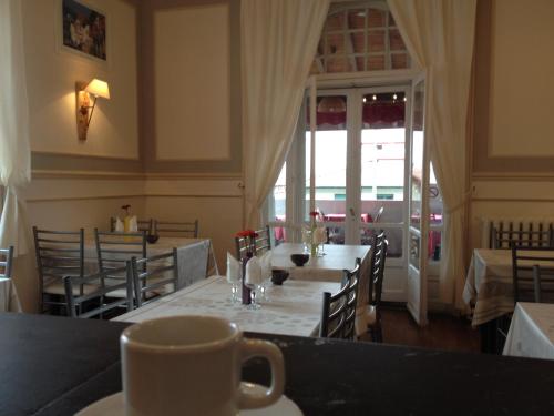 a restaurant with a table with a cup of coffee at Hotel Bellevue in Hendaye