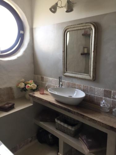 a bathroom with a sink and a mirror at Domaine Sainte Suzanne in Puimisson