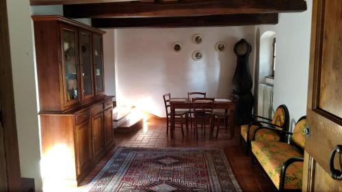 a living room with a table and a dining room at Villa La Nussa in Capolona
