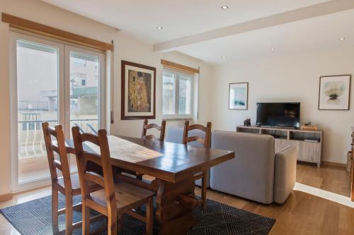 a dining room with a table and a couch at 2 Bedroom Belem Wonder by LovelyStay in Lisbon