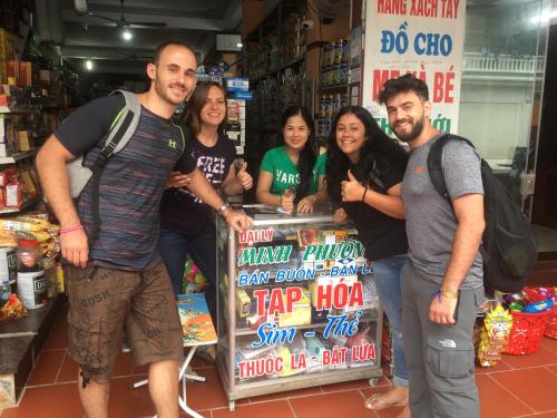 a group of people standing around a sign in a store at Ruby Hostel Hà Giang in Ha Giang