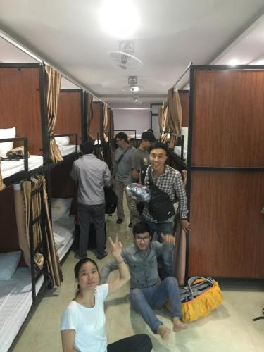a group of people in a room with bunk beds at Ruby Hostel Hà Giang in Ha Giang