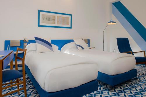 a bedroom with a bed and a table and chairs at Parco dei Principi in Sorrento