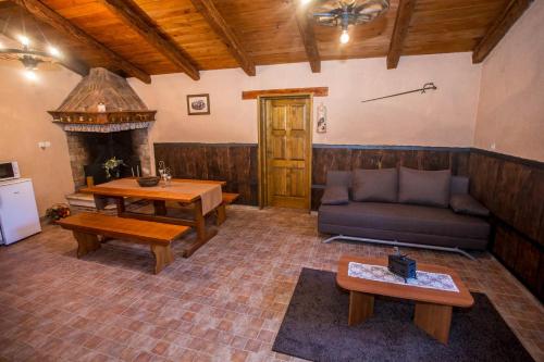 a living room with a couch and a table at Holiday House Legovic in Nova Vas