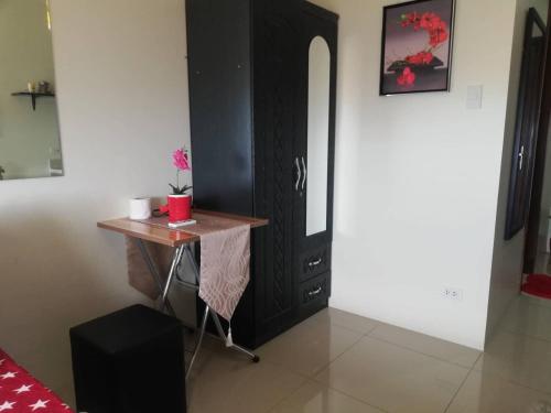 a room with a desk and a black cabinet at Nica's Place Property Management Services at Horizons 101 Condominium in Cebu City