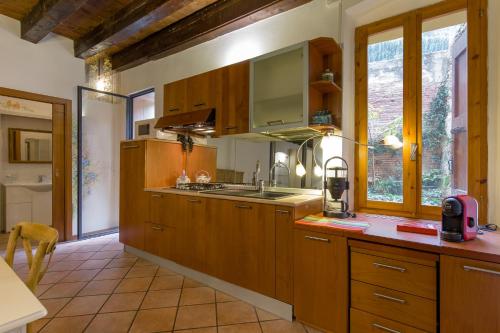 eine Küche mit Holzschränken und einer Arbeitsplatte in der Unterkunft Casa al Teatro in Verona