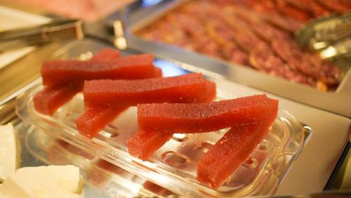 a plastic container with a cut up piece of watermelon at Soho Boutique Casa Don Fernando in Cáceres