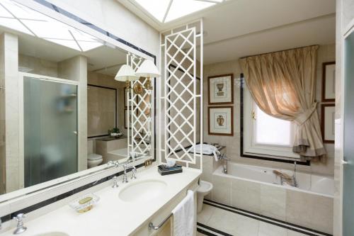 La salle de bains est pourvue d'un lavabo, d'une baignoire et d'un miroir. dans l'établissement Magnificent Villa Piera, à Maspalomas