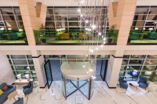 an overhead view of a lobby with a table and chairs at Best Western Premier Batumi in Batumi