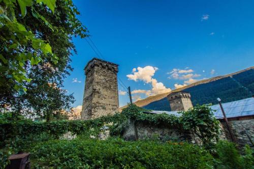 a building with two towers on top of it at Guesthouse Chela in Mestia