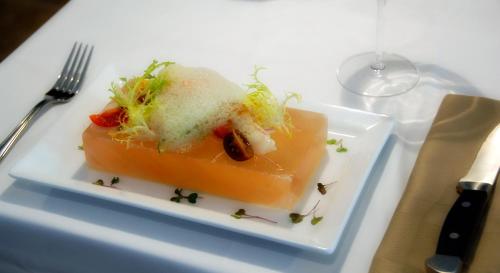 a white plate with a piece of food on a table at Provident Doral At The Blue in Miami
