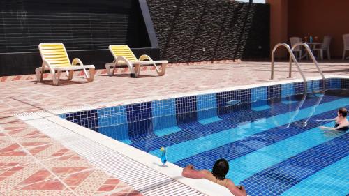 a couple of people in a swimming pool at Crystal Palace Hotel in Manama