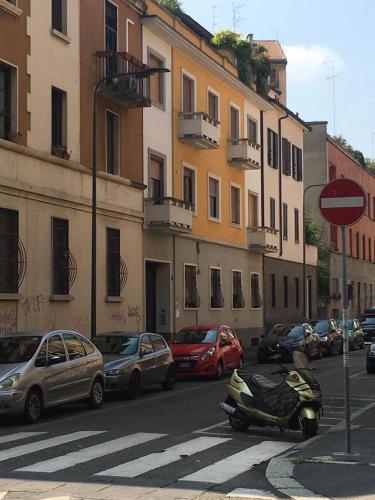 a motorcycle parked on the side of a city street at Maison SAGM&C in Milan