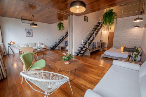 a living room with a couch and a table and chairs at Corner Villa in Bangkok