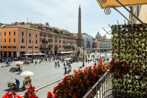 a view of a city street with people and flowers at Hub Navona in Rome