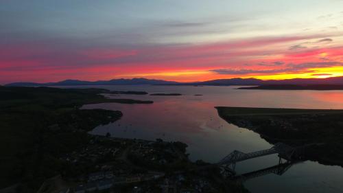 an aerial view of a lake at sunset at Tyndrum Lodges in Tyndrum