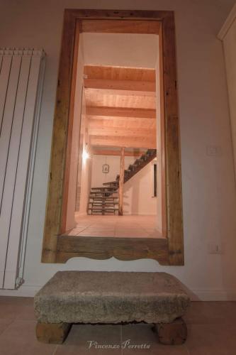 a mirror on the wall of a room with a stairway at L' Alcova Del Conte in Dragoni