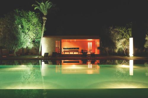 a house with a swimming pool at night at Dar Sabra in Marrakech