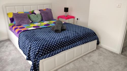 a dog laying on a bed in a bedroom at AdB in Hemel Hempstead