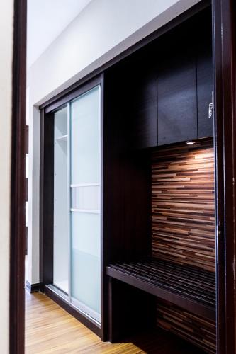 a kitchen with black cabinets and a large window at Classy Studio Apartment (KBCP) in Kota Bharu
