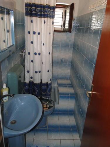 a bathroom with a sink and a toilet and a shower at Radojka in Primošten