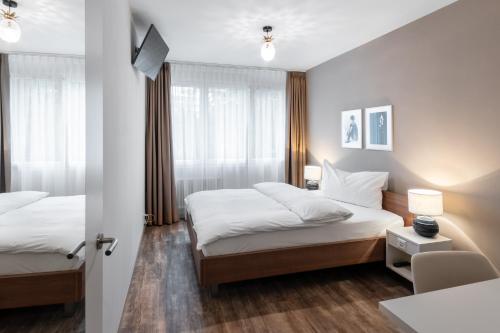Un pat sau paturi într-o cameră la Hotel Birsighof Basel City Center