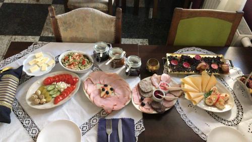 a table with many plates of food on it at Rezydencja Bakamus in Sandomierz