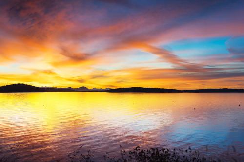 a sunset over a large body of water at 57 Mud Bay in Islandale