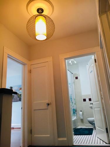 a hallway with a door and a light fixture at Best Bedroom Next to JHU in Baltimore