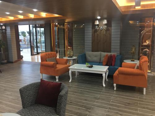 a lobby with a couch and chairs and a table at Golden Bujari AlUlaya Hotel in Al Khobar