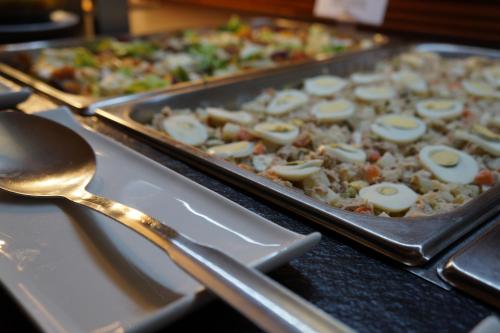 a tray of food with eggs on top of it at Hotel Xalet Verdú in Arinsal