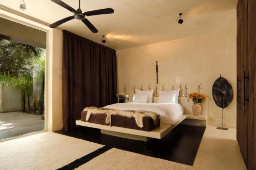 a bedroom with a large bed and a large window at Dar Sabra in Marrakesh