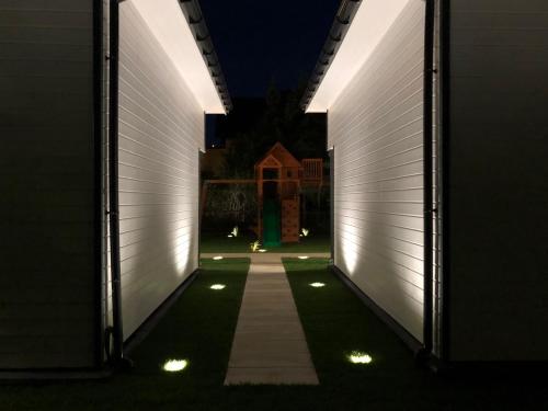 a hallway of a house at night with lights at Tu Urlop in Mielno