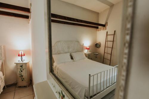 a bedroom with a white bed and a mirror at antonella home in Brindisi