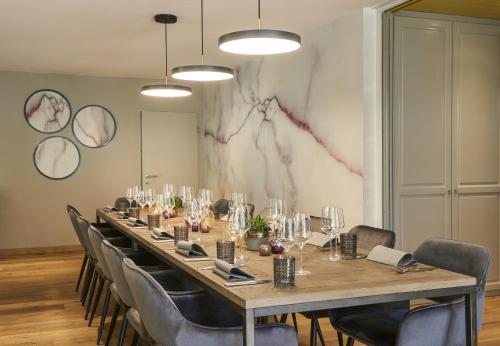 a long table in a room with chairs around it at QUARTIER 82 by Arcadeon in Hagen