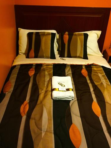 a bed with two towels on top of it at Hostal GQ in Lima
