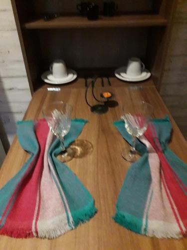 een tafel met twee servetten en twee wijnglazen erop bij Chalés do Alcantilado in Santo Antônio do Pinhal