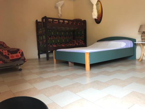 a bedroom with a bed and a table in a room at The Gunjur Project Lodge in Gunjur