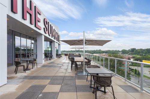 a patio with tables and chairs on a building at The Summit Hotel in Cincinnati