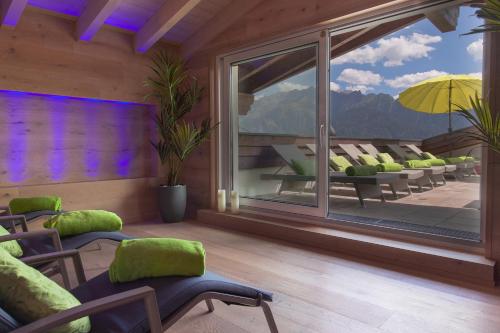a living room with chairs and a large window at ... mein romantisches Hotel Toalstock in Fiss