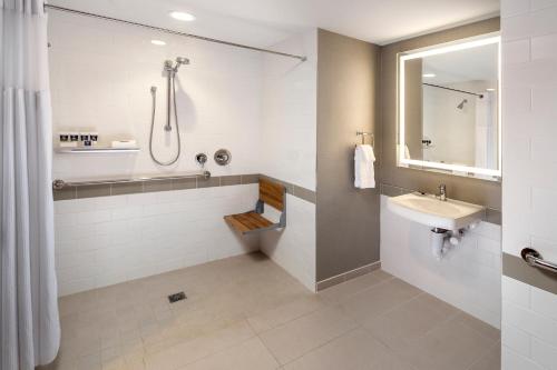 a bathroom with a sink, toilet and bathtub at The Summit Hotel in Cincinnati