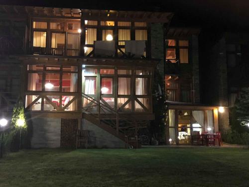a building with a staircase in front of it at night at Вила Комплекс Катарино in Razlog