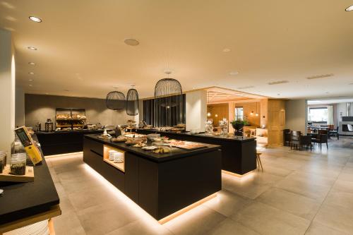 a large kitchen with a large island in a room at Hotel Dorner B&B in Lagundo