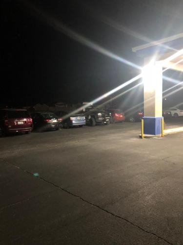a gas station at night with cars parked in a parking lot at Super 8 by Wyndham Chenoa in Chenoa