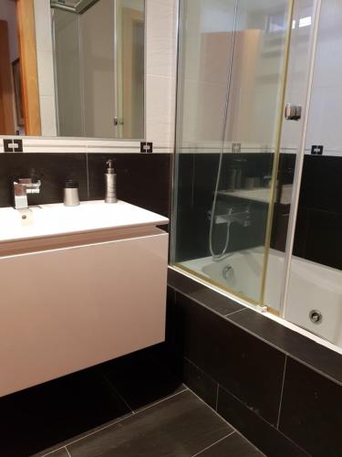 a bathroom with a white sink and a shower at casazul in San Pedro