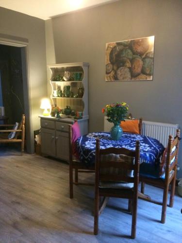 a dining room with a table with a vase on it at Stylish room near seafront in Cleethorpes