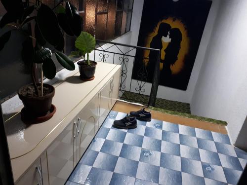 a room with a blue and white checkered floor at Iliovski Inn - Just Like Home in Prilep