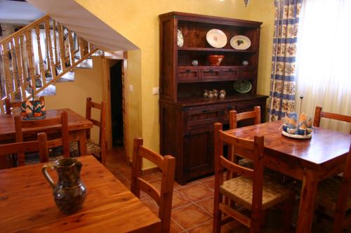a dining room with a table and chairs and a staircase at Casa Rural Valle Esgueva in Burgos