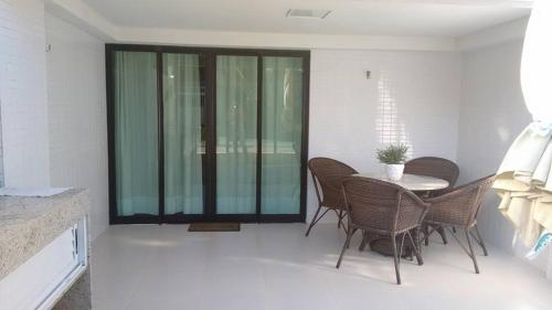 a dining room with a table and chairs at Tabatinga Residence Service - Flat 02 in Conde
